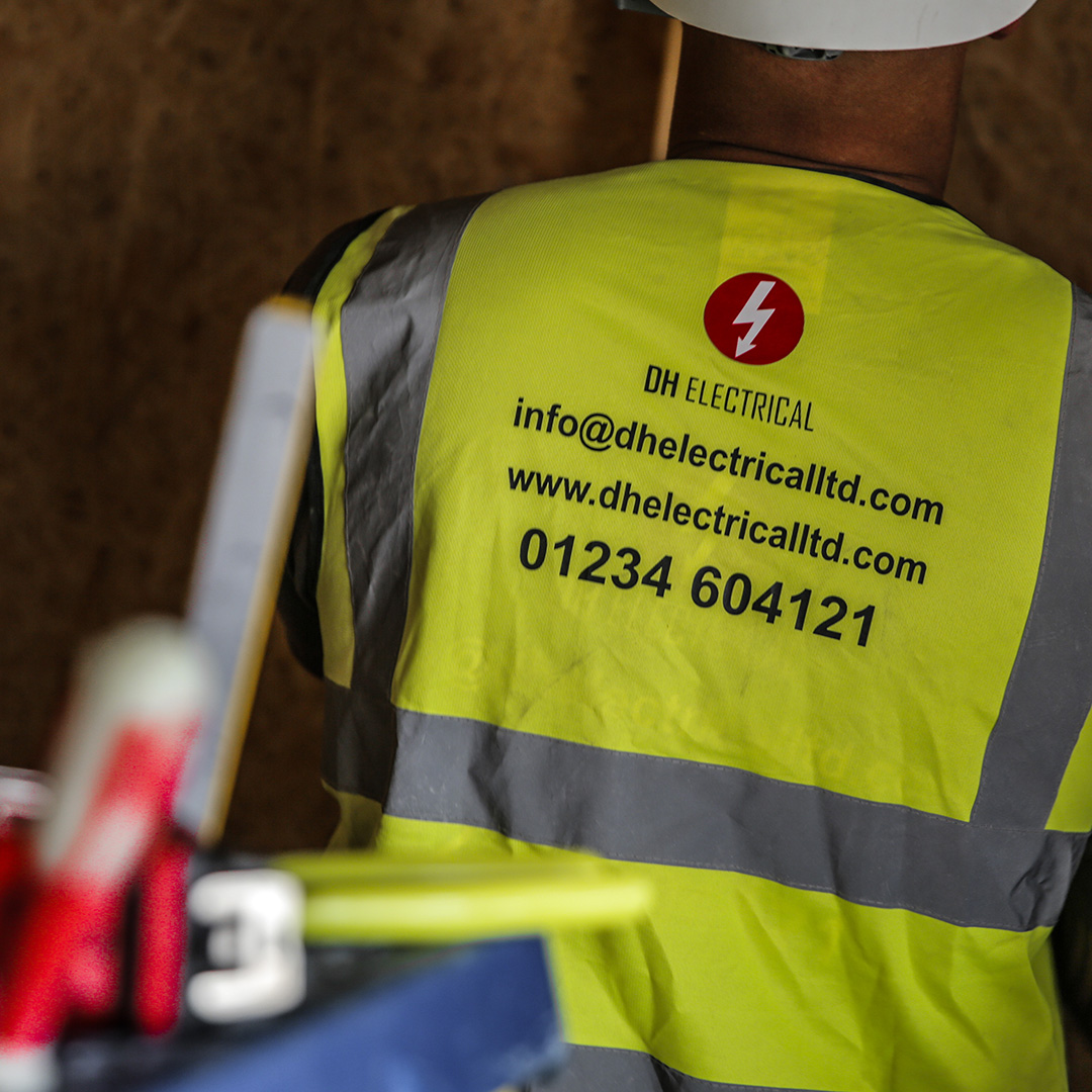End-to-end testing. Employee in hi-vis vest with visible contact details