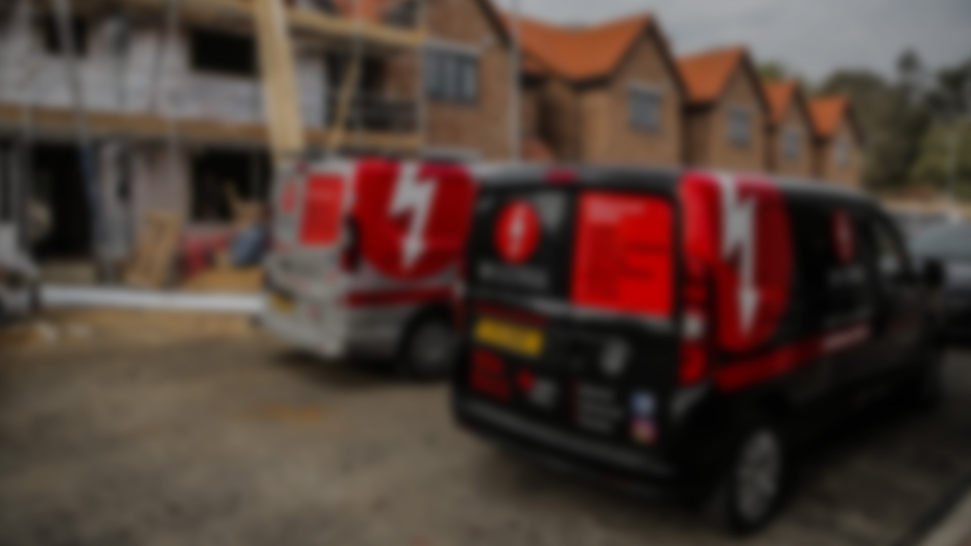 Cover Image. DH Electrical vans outside new build property